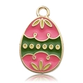 Macro view of Easter egg pendant charm with pink and green enamel and gold leaf details - Pink and Green Egg