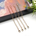 Detailed view of four golden 10cm iron extender chains with lobster clasps for DIY jewelry - Double Lobster Clasp KC Gold Extender Chain (18785)