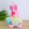 Detail of pink Easter gnome with bunny ears holding a blue polka dot egg on wood - Holding Egg Style / Easter Gnome Male Style