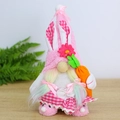 Close-up of pink Easter gnome plush with plaid ears holding a small orange carrot - Holding Carrot Style / Easter Gnome Female Style