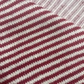 Close-up of soft red and white striped knitted fabric texture and fine fiber detail - White and Vermilion