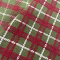 Close-up of red and green plaid knitted fabric with festive Christmas patterns - Green+Red