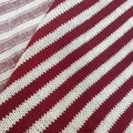 Macro shot of red and white striped knit fabric with soft texture for winter apparel - Wide Red And White