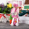 Pink knitted Easter bunny gnome with carrot and tulip garden background decoration - Rose Red