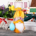 Knitted Easter gnome with yellow floral hat and blue egg for home festival decoration - Yellow