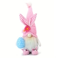Pink Easter gnome plush with bunny ears holding a blue polka dot egg ornament - Male Rabbit with Egg