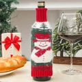 Close-up of a festive knitted snowman wine bottle cover in a cozy holiday setting - Christmas Snowman Style