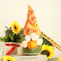 Fall Harvest Gnome doll with maple leaf hat holding a bright orange pumpkin ornament - White Beard
