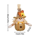 Detail showing 20cm autumn scarecrow gnome with sunflower hat and pumpkin base - Female Style