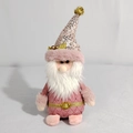 Detailed shot of pink Christmas gnome plush with sequined hat and thick white beard - Santa Claus Gnome