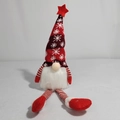 Detailed view of a Christmas gnome with a red snowflake knit hat and long striped legs - Red