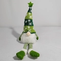 Detail of a Christmas gnome doll with green striped knit hat and white snowflake patterns - Green