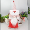 Macro view of Valentine's gnome holding a white envelope with a red glitter heart - Large Envelope Style