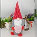 Close-up of gnome plush with red star hat holding a pink heart for Valentine decor - Large Heart