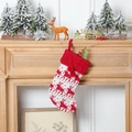 Red and white knitted Christmas stocking with reindeer patterns and pompoms - Knitted Reindeer Stocking