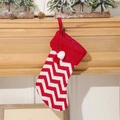 Knitted Christmas stocking with red and white chevron pattern and decorative pom poms - Knitted Red White Stripe Stocking