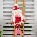 Valentine gnome plush with red heart knit hat and white braids on a bamboo ladder - Female Style