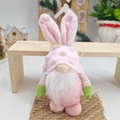Pink Easter gnome plush with rabbit ears on a wooden bench for festive home decoration - Pink