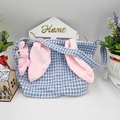 Blue houndstooth Easter basket with pink bunny ears and plush charm on white background - Blue