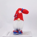 Patriotic July 4th gnome plush with red star hat and white beard on a white stand - Red Hat