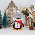 Close-up of plush Christmas penguin doll with knitted hat and red snowflake scarf decor - Grey Hat Standing Penguin