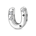Macro detail of silver letter U charm with cubic zirconia star pattern for jewelry making - Letter U