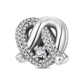 Macro shot of silver knot charm with sparkling pavé cubic zirconia and large center stone - Endless Love Bead (PAC2007)