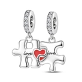 Macro detail of silver wings heart puzzle charm with Love engraving and red enamel finish - Love Puzzle Piece Charm (PAC1783)
