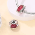 Macro detail of purple luminous glass charm with LOVE engraving on silver snake chain - Cherry Glass Bead