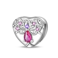 Macro shot of silver heart charm with pink pear-shaped stone and purple crystal accents - Pink Tree of Life