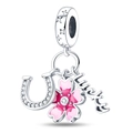 Macro shot of silver lucky charm featuring a pink enamel sakura and a horseshoe with crystals - Cherry Blossom Charm (PAC385)