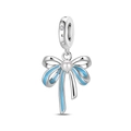Detailed view of silver bow charm with sky blue enamel and center white pearl inlay - Blue Bow Pendant