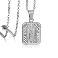 Silver square pendant necklace featuring embossed letter N and textured metallic finish - Letter N / Steel