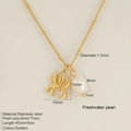 Golden stainless steel spider necklace featuring a white freshwater pearl accent pendant - Spider