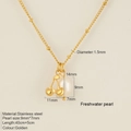Golden stainless steel chain necklace featuring cherry charm and freshwater pearl pendant - Cherry