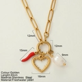 Collana a graffetta in acciaio dorato con peperoncino, cuore traforato e perla - Cuore Spinoso