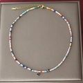 Bohemian colorful beaded necklace featuring a blue heart pendant and golden chain link - Blue Heart
