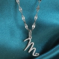 Zilveren roestvrijstalen ketting met cursieve letter M hanger en subtiel hartje - Staal-M