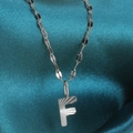 Silver stainless steel necklace with letter F pendant featuring radial engraved texture - Letter F / Silver