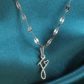 Zilveren roestvrijstalen ketting met letterhanger en een klein uitgehold hartje - Staal-F