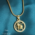 Golden Leo zodiac necklace with crystal pavé pendant on premium blue silk background - Leo
