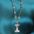 Silver letter I necklace with textured sunburst pendant on fine chain over teal silk - Letter I / Silver