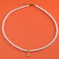 Gold plated pearl necklace featuring a letter B pendant and a tiny heart detail - Letter B (NK228ZP39270-2)