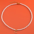 Elegant white pearl necklace with 18K gold plated letter C heart pendant on orange base - Letter C (NK228ZP39270-2)