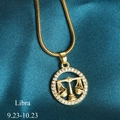 Golden Libra zodiac necklace with crystal circle pendant and snake chain on blue silk - Libra