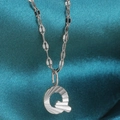 Polished silver stainless steel necklace with letter Q pendant featuring radial texture - Letter Q / Silver