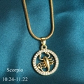Golden Scorpio zodiac pendant necklace with crystal inlay on blue silk background - Scorpio