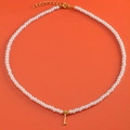 Elegant white pearl necklace with 18K gold plated heart pendant on orange background - Letter I (NK228ZP39270-2)