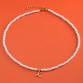 Pearl necklace featuring gold letter K heart pendant on a vibrant orange background - Letter K (NK228ZP39270-2)