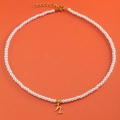 18K gold plated pearl necklace featuring a cursive 'h' letter pendant on orange background - Letter N (NK228ZP39270-2)